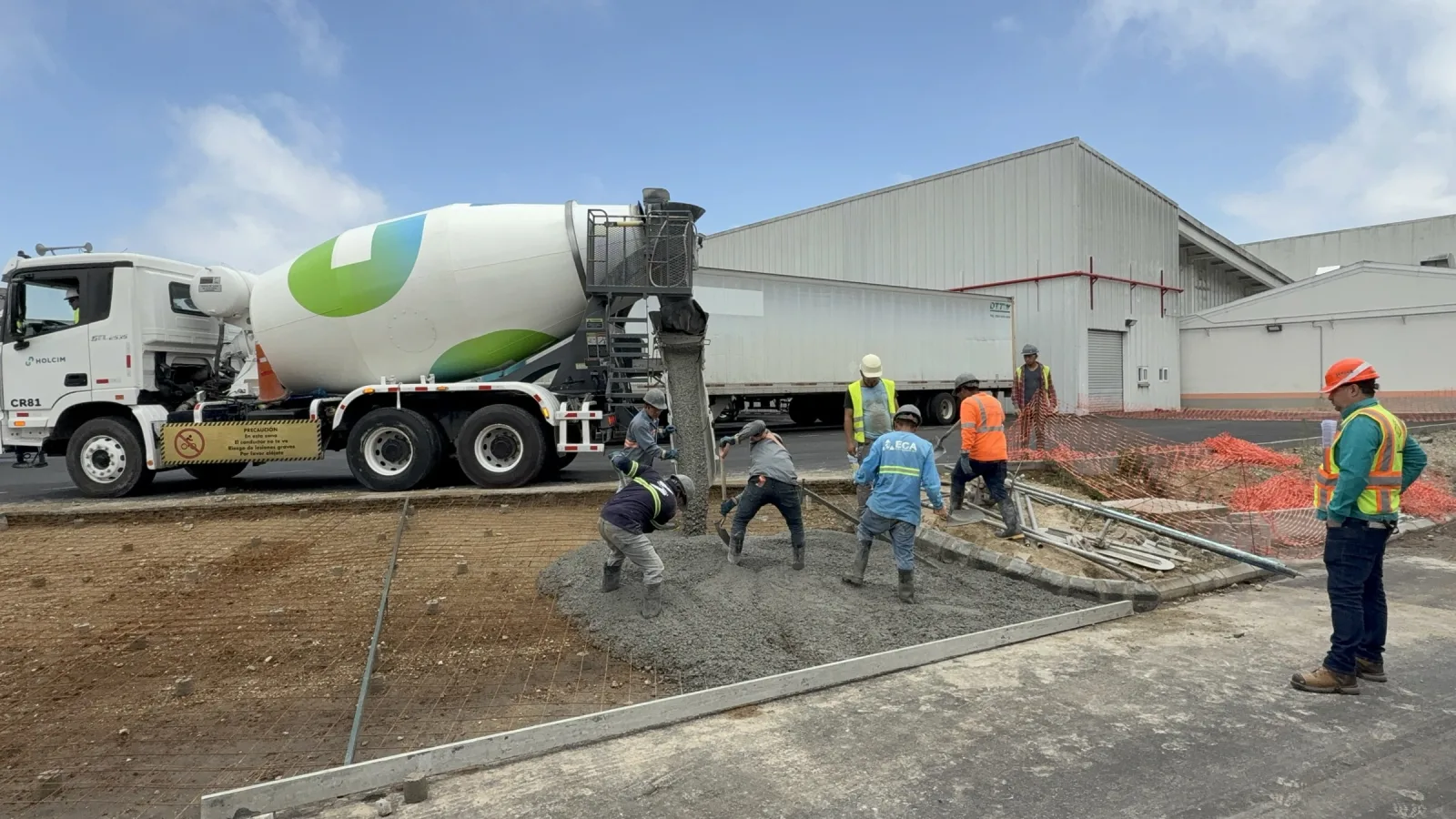 Fundición de concreto en el área de maniobras de una bodega industrial, con supervisión técnica en obra.